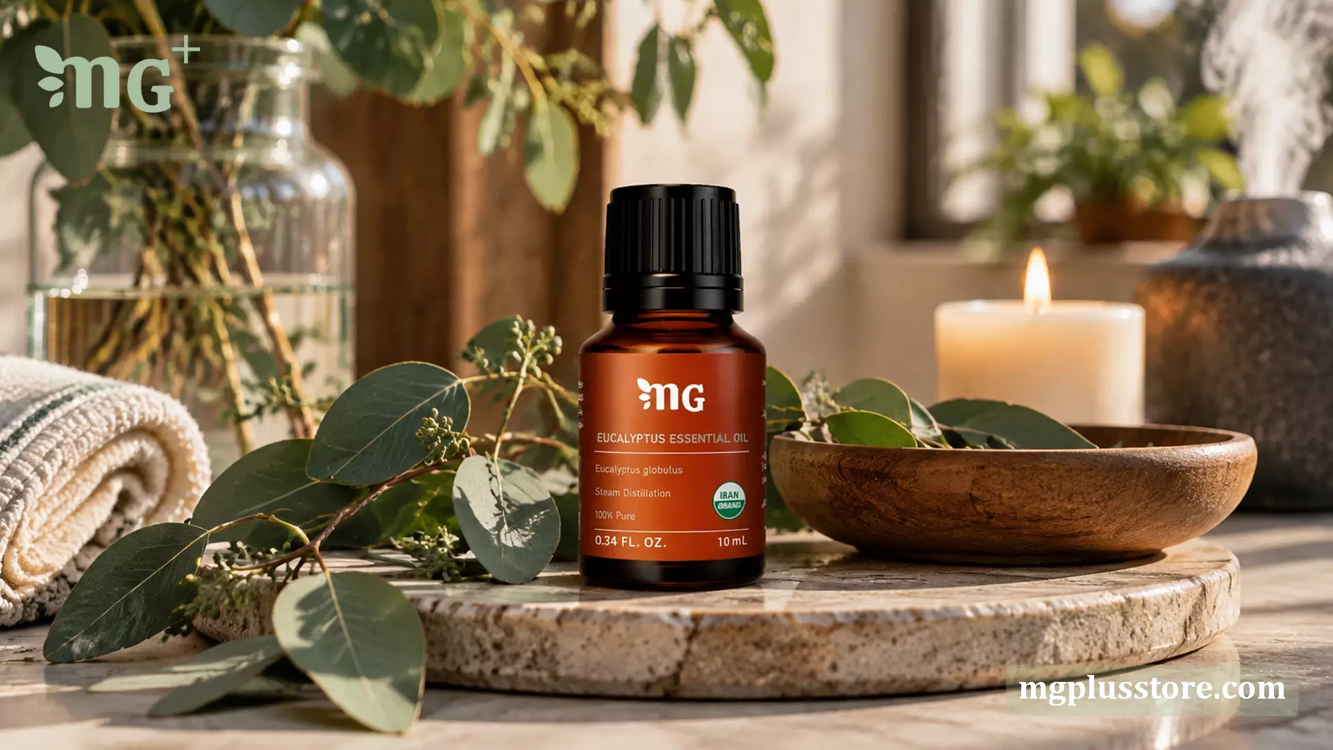 شیشه ۱۰ میلیلیتری روغن اسانسی اکالیپتوس ۱۰۰٪ خالص و ارگانیک ام جی پلاس (MG Plus) روی پایه سنگی، در کنار برگهای طبیعی، شمع روشن و بخار دستگاه دیفیوزر.